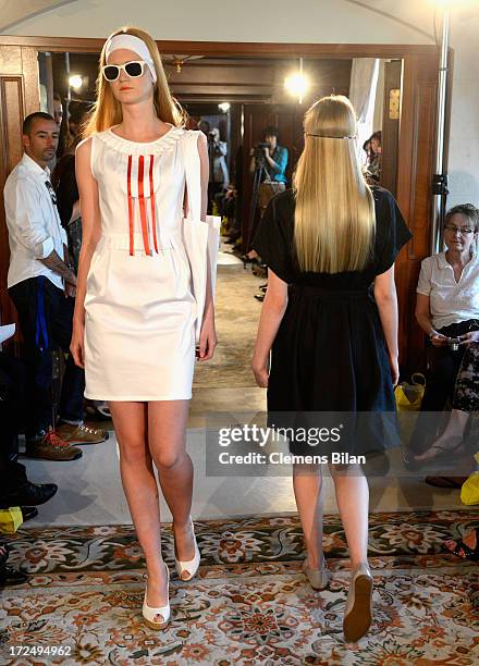 Models walk the runway at the Green Showroom during Mercedes-Benz Fashion Week Spring/Summer 2014 at Brandenburg Gate on July 2, 2013 in Berlin,...