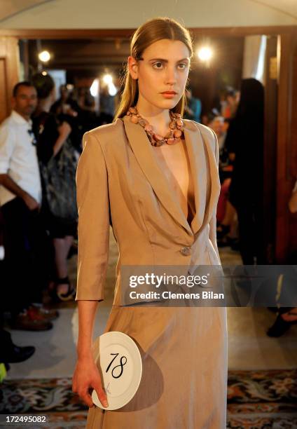 Model walks the runway at the Green Showroom during Mercedes-Benz Fashion Week Spring/Summer 2014 at Brandenburg Gate on July 2, 2013 in Berlin,...