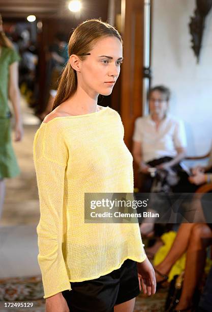 Model walks the runway at the Green Showroom during Mercedes-Benz Fashion Week Spring/Summer 2014 at Brandenburg Gate on July 2, 2013 in Berlin,...