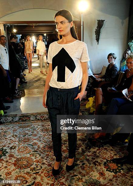 Model walks the runway at the Green Showroom during Mercedes-Benz Fashion Week Spring/Summer 2014 at Brandenburg Gate on July 2, 2013 in Berlin,...