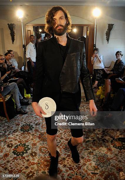 Model walks the runway at the Green Showroom during Mercedes-Benz Fashion Week Spring/Summer 2014 at Brandenburg Gate on July 2, 2013 in Berlin,...