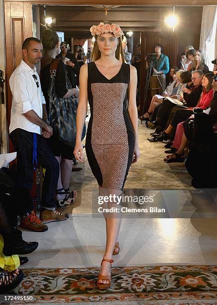 Model walks the runway at the Green Showroom during Mercedes-Benz Fashion Week Spring/Summer 2014 at Brandenburg Gate on July 2, 2013 in Berlin,...