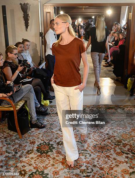 Model walks the runway at the Green Showroom during Mercedes-Benz Fashion Week Spring/Summer 2014 at Brandenburg Gate on July 2, 2013 in Berlin,...