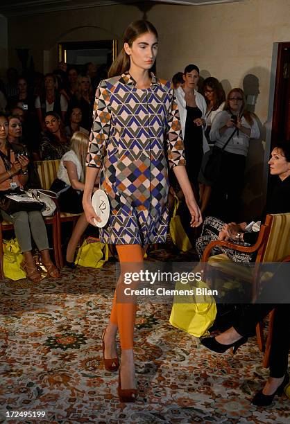 Model walks the runway at the Green Showroom during Mercedes-Benz Fashion Week Spring/Summer 2014 at Brandenburg Gate on July 2, 2013 in Berlin,...