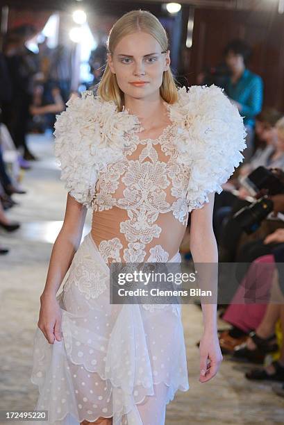 Model walks the runway at the Green Showroom during Mercedes-Benz Fashion Week Spring/Summer 2014 at Brandenburg Gate on July 2, 2013 in Berlin,...