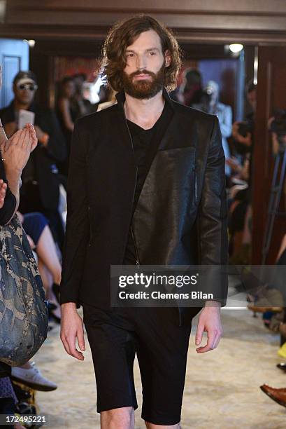 Model walks the runway at the Green Showroom during Mercedes-Benz Fashion Week Spring/Summer 2014 at Brandenburg Gate on July 2, 2013 in Berlin,...