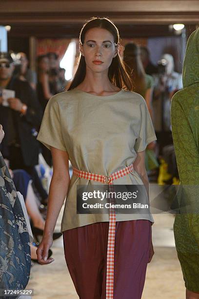 Model walks the runway at the Green Showroom during Mercedes-Benz Fashion Week Spring/Summer 2014 at Brandenburg Gate on July 2, 2013 in Berlin,...