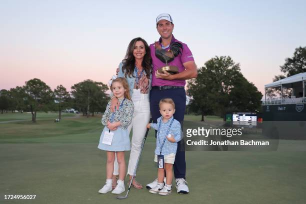 Luke List of the United States celebrates with the trophy alongside wife Chloe, daughter Ryann and son Harrison after winning the Sanderson Farms...