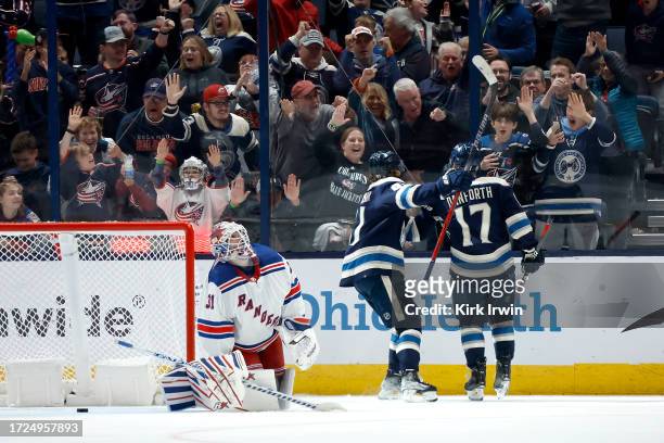 Justin Danforth of the Columbus Blue Jackets is congratulated by Kent Johnson after beating Igor Shesterkin of the New York Rangers for a goal during...