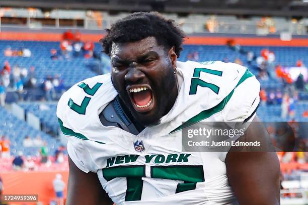 Mekhi Becton of the New York Jets celebrates after beating the Denver Broncos 31-21 at Empower Field At Mile High on October 08, 2023 in Denver,...