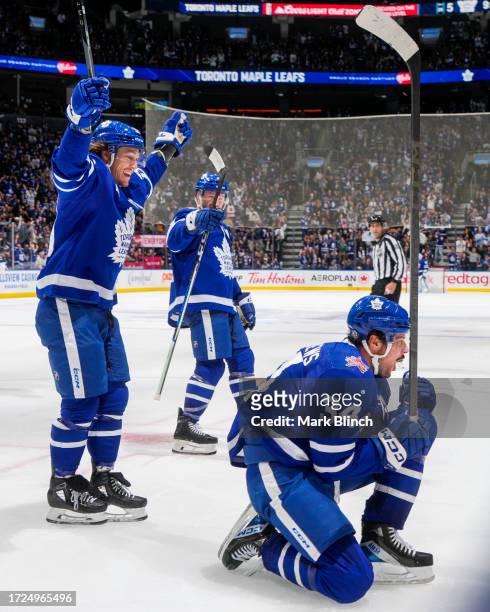 Auston Matthews of the Toronto Maple Leafs celebrates his third goal of the game against the Minnesota Wild with teammates Tyler Bertuzzi and Morgan...