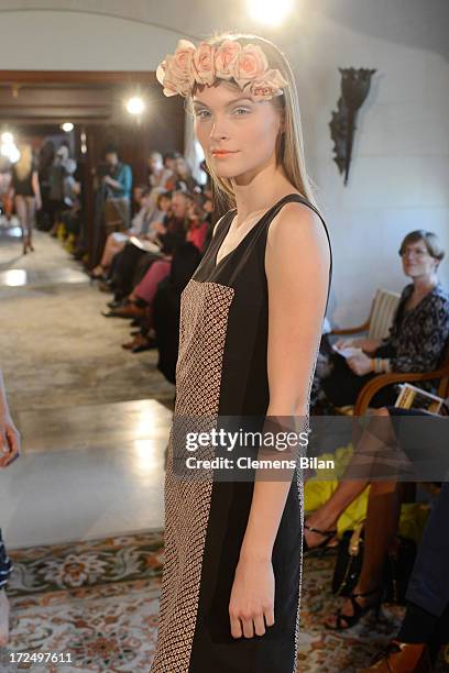 Model walks the runway at the Green Showroom during Mercedes-Benz Fashion Week Spring/Summer 2014 at Brandenburg Gate on July 2, 2013 in Berlin,...