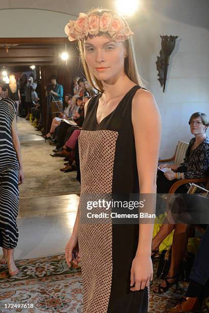 Model walks the runway at the Green Showroom during Mercedes-Benz Fashion Week Spring/Summer 2014 at Brandenburg Gate on July 2, 2013 in Berlin,...