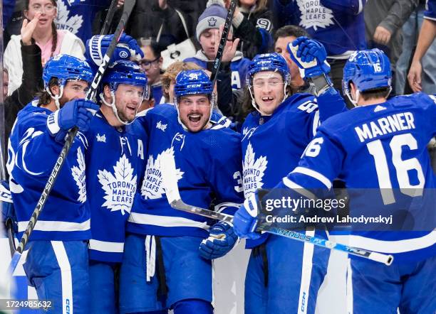 Auston Matthews of the Toronto Maple Leafs celebrates his third goal of the game against the Minnesota Wild with teammates TJ Brodie, Morgan Rielly,...