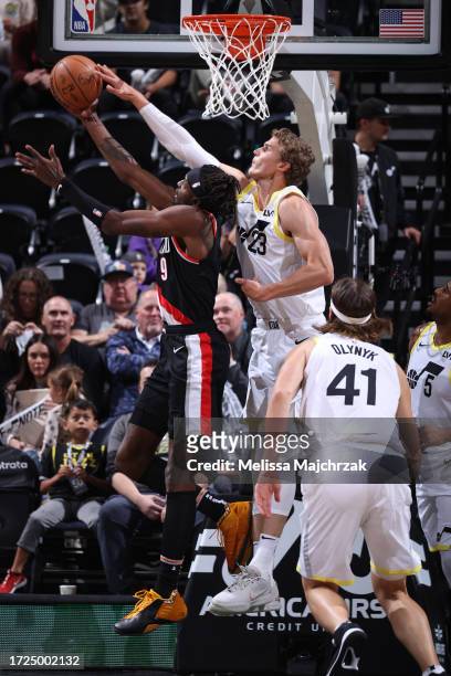 Lauri Markkanen of the Utah Jazz blocks the shot by Jerami Grant of the Portland Trail Blazers during the preseason game on October 14, 2023 at...