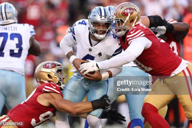 Dak Prescott of the Dallas Cowboys is sacked by Nick Bosa and Arik Armstead of the San Francisco 49ers during the first quarter at Levi's Stadium on...