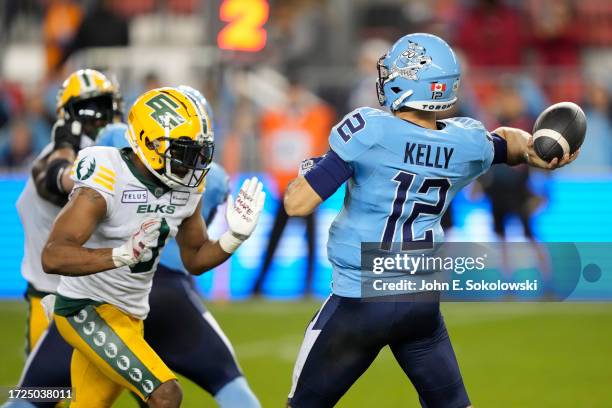 Chad Kelly of the Toronto Argonauts goes to throw a pass as Loucheiz Purifoy of the Edmonton Elks closes in at BMO Field on October 6, 2023 in...