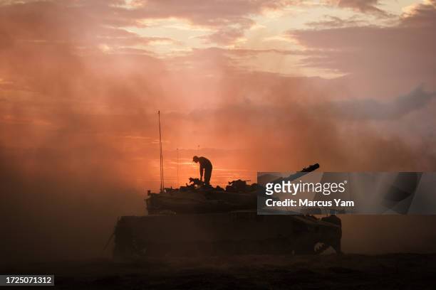 Israeli Merkava battle tank units regroup near the border of Gaza, in the southern part of Israel, Saturday, Oct. 14, 2023. Israel was caught by...