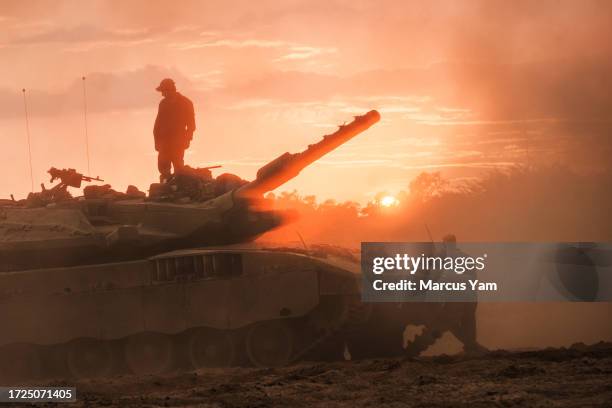 Israeli Merkava battle tank units regroup near the border of Gaza, in the southern part of Israel, Saturday, Oct. 14, 2023. Israel was caught by...