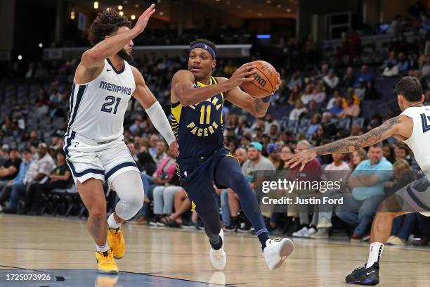 Bruce Brown of the Indiana Pacers drives against David Roddy of the Memphis Grizzlies in the first half at FedExForum on October 08, 2023 in Memphis,...