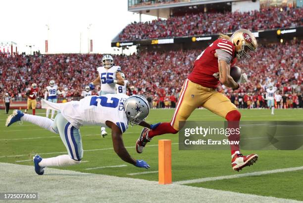 George Kittle of the San Francisco 49ers runs for a touchdown after a catch during the second quarter against the Dallas Cowboys at Levi's Stadium on...