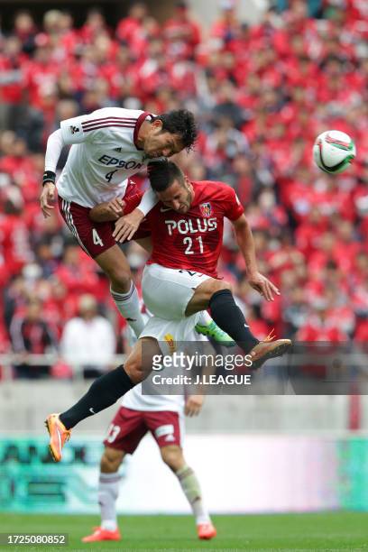 Masaki Iida of Matsumoto Yamaga and Zlatan Ljubijankic of Urawa Red Diamonds compete for the ball during the J.League J1 first stage match between...