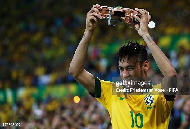 Neymar of Brazil celebrates with the adidas Bronze Boot award after the FIFA Confederations Cup Brazil 2013 Final match between Brazil and Spain at...