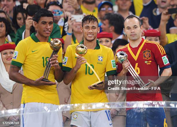 Paulinho of Brazil holds the adidas Bronze Ball award, Neymar of Brazil holds the adidas Golden Ball award and Andres Iniesta of Spain holds the...