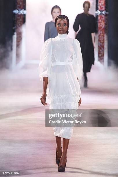 Model walks the runway during the Ulyana Sergeenko show as part of Paris Fashion Week Haute-Couture Fall/Winter 2013-2014 at on July 2, 2013 in...