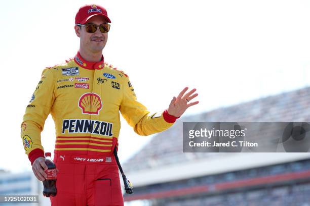 Joey Logano, driver of the Shell Pennzoil Ford, waves to fans as he walks onstage during driver intros prior to the NASCAR Cup Series Bank of America...
