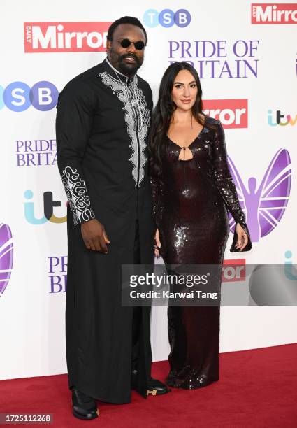 Derek Chisora and guest arrive at the Pride Of Britain Awards 2023 at Grosvenor House on October 08, 2023 in London, England.