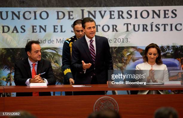 Enrique Pena Nieto, Mexico's president, center, speaks about investment in the tourism sector while Alejandro Zozaya, chief executive officer of...
