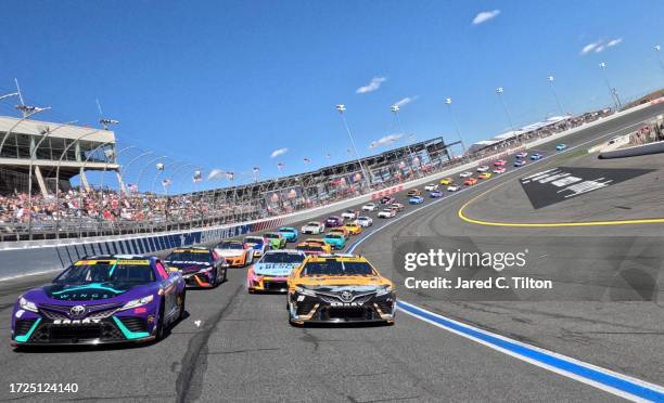 Tyler Reddick, driver of the Jordan Brand Toyota, and Christopher Bell, driver of the DEWALT Plumbing Solutions Toyota, lead the field on a pace lap...