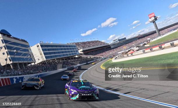 Tyler Reddick, driver of the Jordan Brand Toyota, and Christopher Bell, driver of the DEWALT Plumbing Solutions Toyota, lead the field on a pace lap...