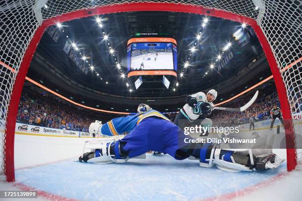 Jordan Binnington of the St. Louis Blues makes a save against Matty Beniers of the Seattle Kraken during a shootout at Enterprise Center on October...