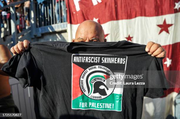 Fans of US Livorno Calcio football show their support for Palestinian after the end of the Ghiviborgo v US Livorno match on October 8, 2023 in...