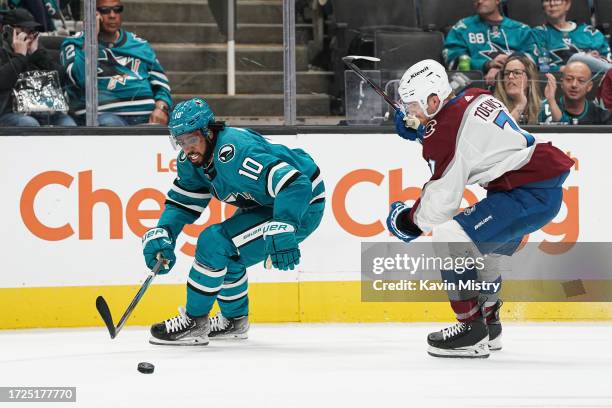 Anthony Duclair of the San Jose Sharks skates with the puck in the first period against Devon Toews of the Colorado Avalanche at SAP Center on...