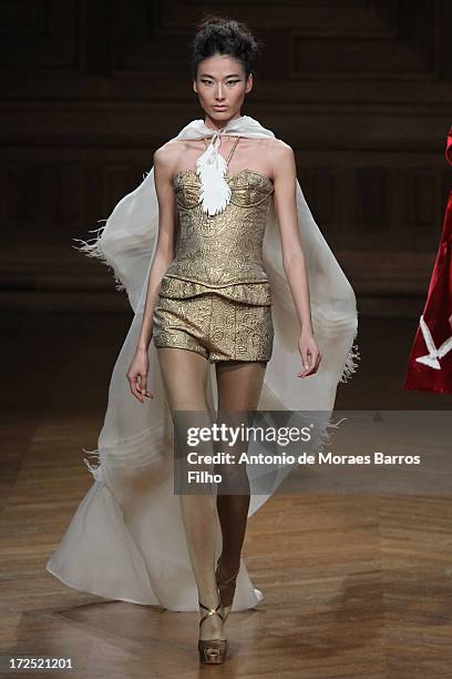 Model walks the runway during the Oscar Carvallo show as part of Paris Fashion Week Haute-Couture Fall/Winter 2013-2014 at Musee Bourdelle on July 2,...