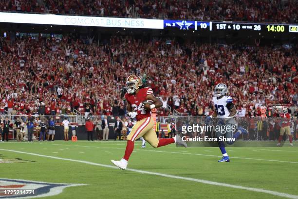 Jordan Mason of the San Francisco 49ers runs for a touchdown during the fourth quarter against the Dallas Cowboys at Levi's Stadium on October 08,...