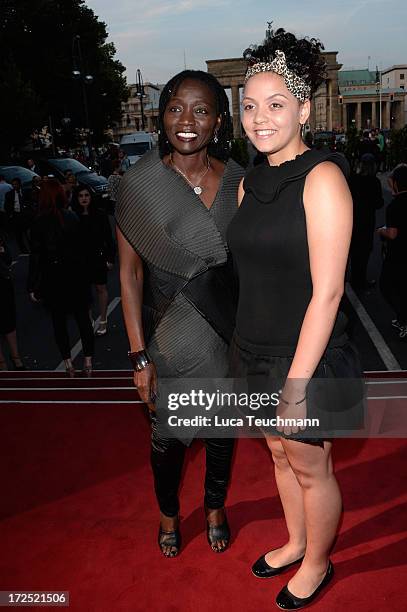 Auma Obama and daughter Akini attend the Arrey Kono, Nadir Tati, Romero Bryan Show during Mercedes-Benz Fashion Week Spring/Summer 2014 at...