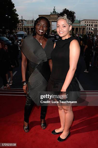 Auma Obama and daughter Akini attend the Arrey Kono, Nadir Tati, Romero Bryan Show during Mercedes-Benz Fashion Week Spring/Summer 2014 at...