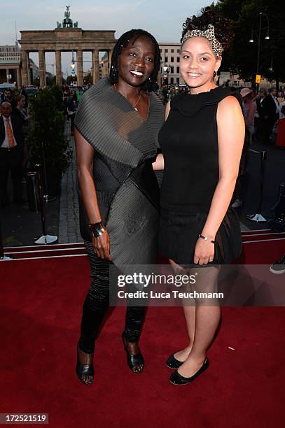 Auma Obama and daughter Akini attend the Arrey Kono, Nadir Tati, Romero Bryan Show during Mercedes-Benz Fashion Week Spring/Summer 2014 at...