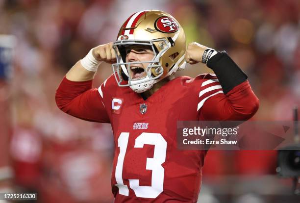 Brock Purdy of the San Francisco 49ers celebrates after a touchdown by Jordan Mason during the fourth quarter against the Dallas Cowboys at Levi's...