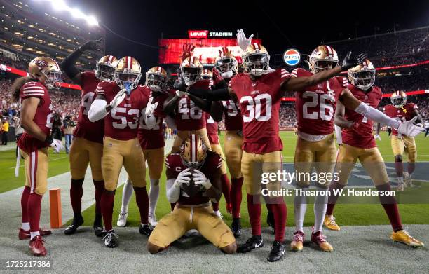 Fred Warner of the San Francisco 49ers celebrates with teammates after an interception during the fourth quarter against the Dallas Cowboys at Levi's...