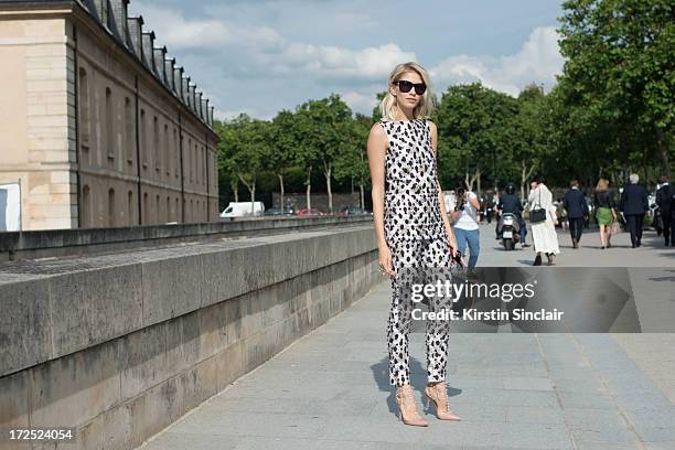 Model Elena Perminova wears Valentino shoes, Emilio Pucci bag and a Giambattista Valli jumpsuit on day 1 of Paris Collections: Womens Haute Couture...