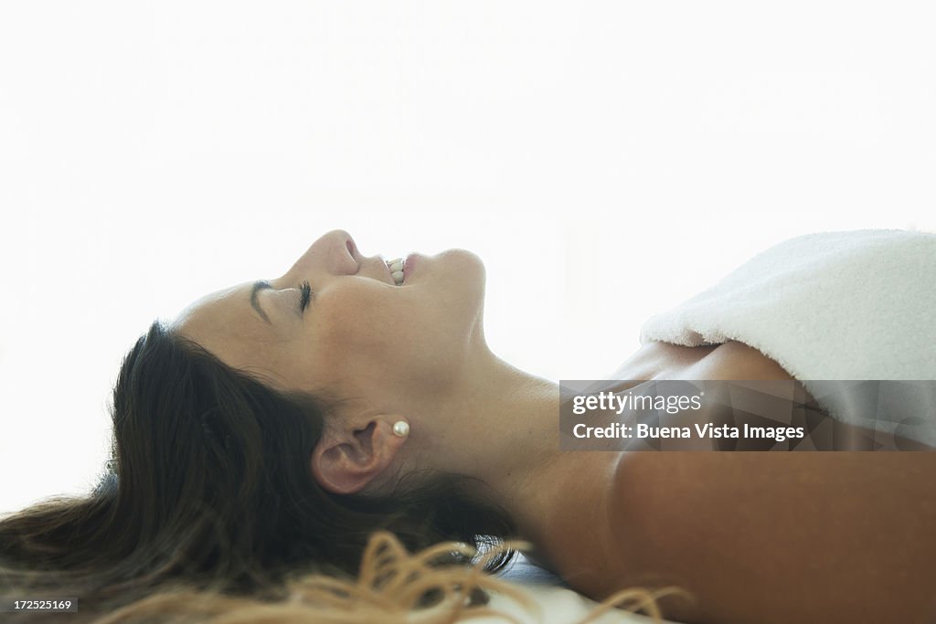 Young woman relaxing in bed