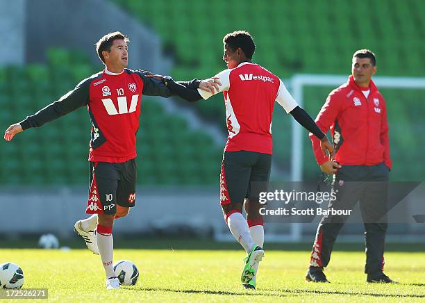Harry Kewell of the Heart stretches as Heart coach John Aloisi looks on during a Melbourne Heart A-League training session at AAMI Park on July 3,...