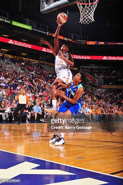 Charde Houston of the Phoenix Mercury shoots against Kamiko Williams of the New York Liberty on July 2, 2013 at U.S. Airways Center in Phoenix,...