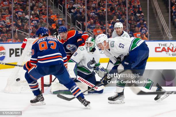 Ryan Nugent-Hopkins and Zach Hyman of the Edmonton Oilers look for a shot against goaltender Casey DeSmith of the Vancouver Canucks during the third...