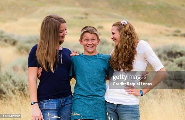 pre-teen boy between two taller teenage girls - finger waves bildbanksfoton och bilder